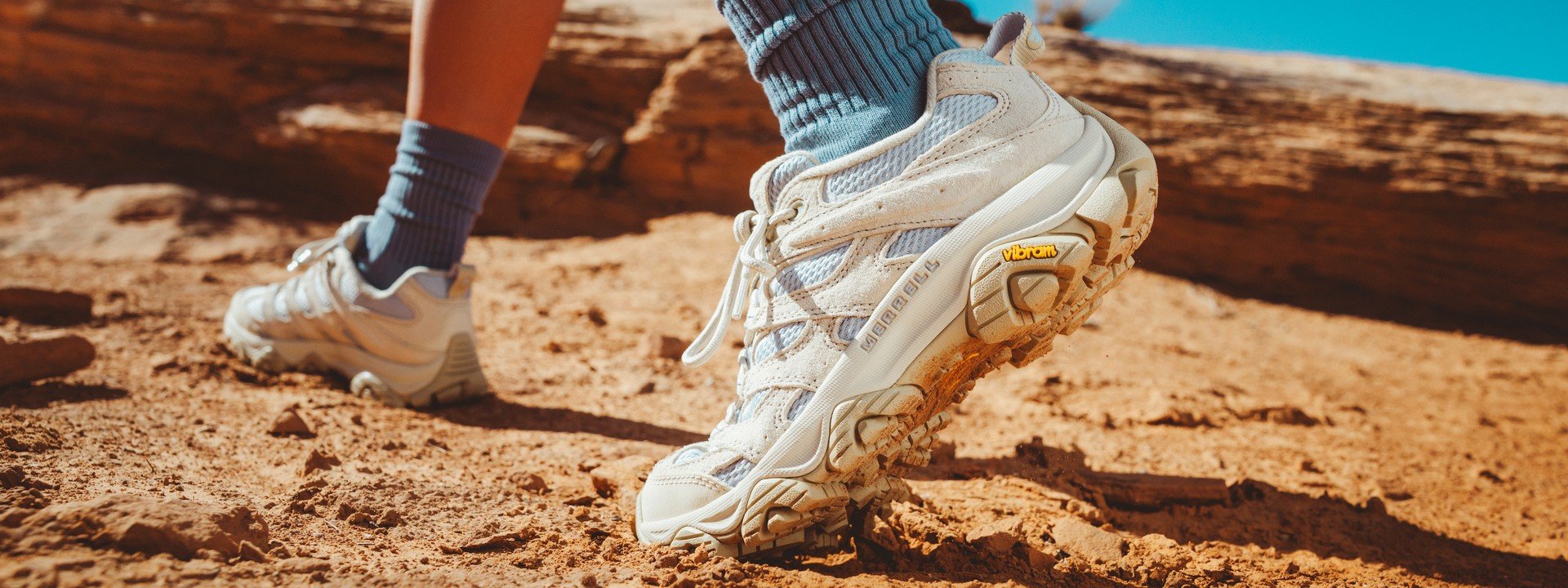 Hiker walking over red rock in Merrell Moab Speed 2 shoes